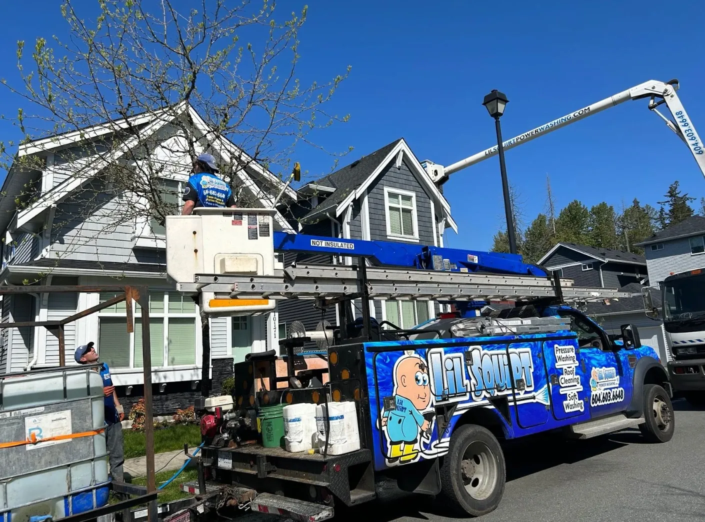 House washing Lil Squirt Power Washing bucket lift truck house washing