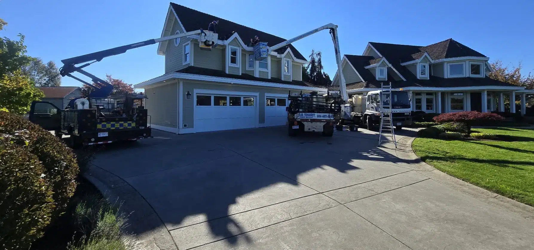 Lil Squirt Power Washing bucket trucks working on a Pitt Meadows BC home